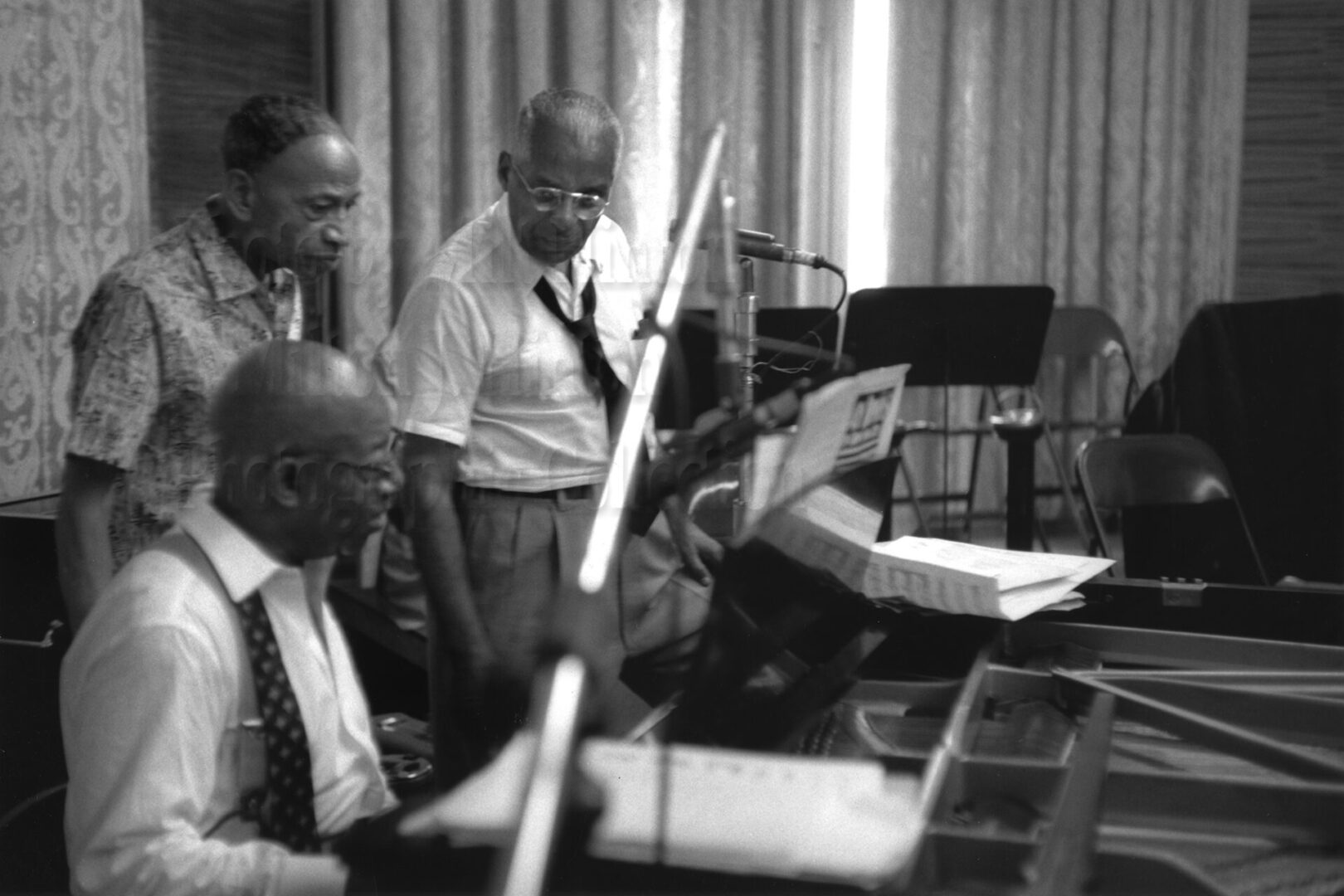 Photo by Milt Hinton<br>
© Milton J. Hinton<br>Photographic Collection <br><b class="captionn">Perry Bradford, Eubie Blake (at piano), and Noble Sissle, NYC c. 1958</b>