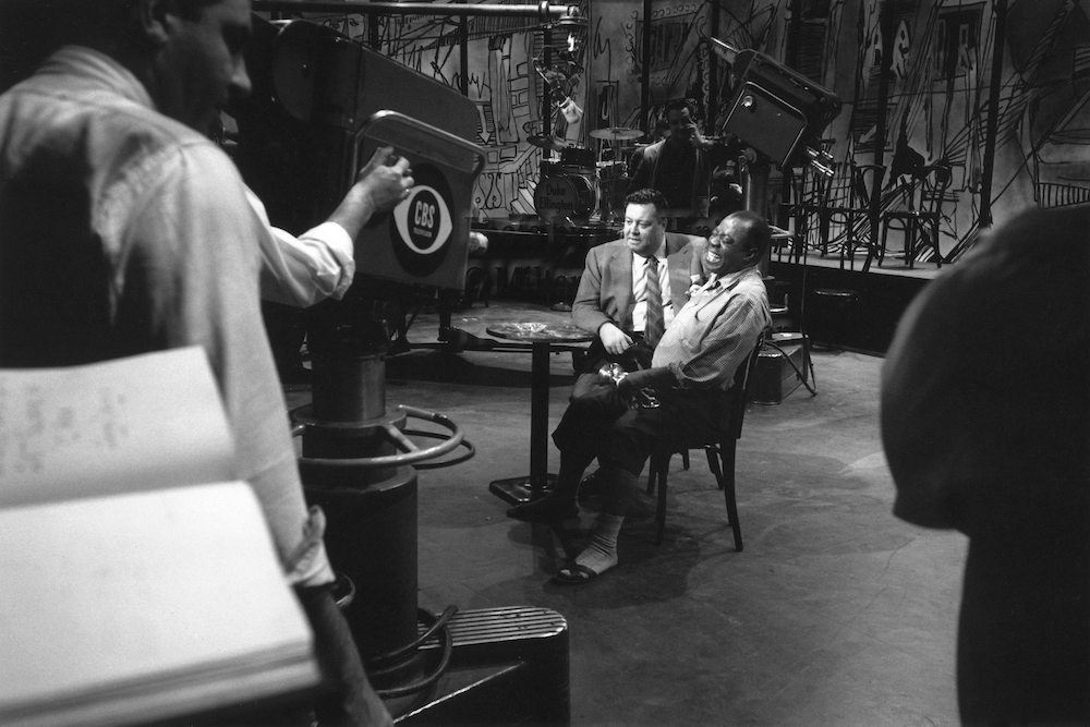 Photo by Milt Hinton<br>
© Milton J. Hinton<br>Photographic Collection <br><b class="captionn">Jackie Gleason and Louis Armstrong, television studio, (Timex rehearsal), New York City, 1959</b>